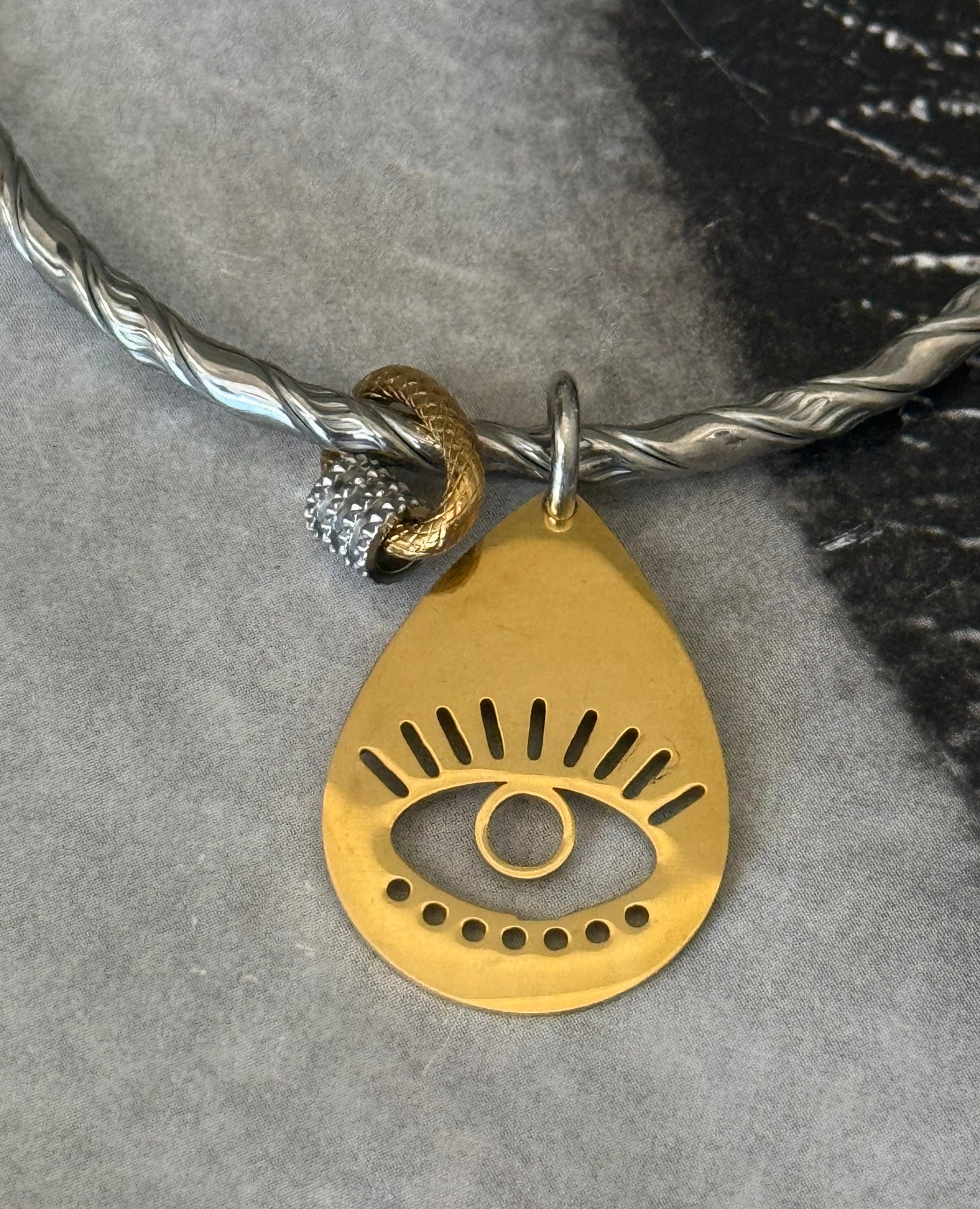 TWIST EYE SILVER BANGLE